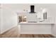 Modern kitchen featuring white cabinetry, stainless appliances, and tile backsplash at 2331 E Delgado St, Phoenix, AZ 85022