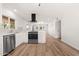 Bright kitchen with stainless appliances, white cabinets, and a view to the next room at 2331 E Delgado St, Phoenix, AZ 85022
