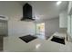 A close-up of the kitchen island showcasing a black range, a black sink, and waterfall countertops at 2331 E Delgado St, Phoenix, AZ 85022