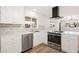 Cozy kitchen features white cabinets, stainless steel appliances, and a tile backsplash at 2331 E Delgado St, Phoenix, AZ 85022