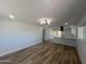 Open-concept living room featuring wood floors, and a kitchen in the background at 2331 E Delgado St, Phoenix, AZ 85022