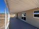 Enclosed patio with dark flooring, sliding glass doors, and a view of the expansive backyard at 2331 E Delgado St, Phoenix, AZ 85022