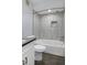 Updated bathroom featuring tile surround, shower head, and modern fixtures at 2333 E Southern Ave # 1015, Tempe, AZ 85282