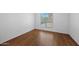 Bedroom featuring wood floors and a window offering natural light at 2625 E Indian School E Rd # 115, Phoenix, AZ 85016