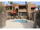 Hot tub and lounge seating within a fenced community area at 2625 E Indian School E Rd # 115, Phoenix, AZ 85016
