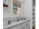 Close-up of kitchen sink with window view and ample counter space at 2625 E Indian School E Rd # 115, Phoenix, AZ 85016