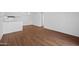 Open-concept living room with wood floors, adjacent to the kitchen at 2625 E Indian School E Rd # 115, Phoenix, AZ 85016