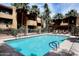 Inviting community pool with lounge chairs and lush landscaping at 2625 E Indian School E Rd # 115, Phoenix, AZ 85016