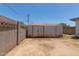 Backyard featuring a block wall and shed, with an unfinished landscape at 3302 W Turney Ave, Phoenix, AZ 85017