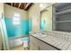 Bathroom featuring a combination shower-tub, sink, toilet, and a mirror at 3302 W Turney Ave, Phoenix, AZ 85017