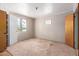 Bedroom featuring a window and access door, with a neutral color scheme and soft carpet at 3302 W Turney Ave, Phoenix, AZ 85017