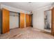Bedroom features a closet and a door to the bathroom; soft carpet and bright lighting at 3302 W Turney Ave, Phoenix, AZ 85017