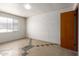 This bedroom has a large window and access door, with light walls and patterned flooring at 3302 W Turney Ave, Phoenix, AZ 85017