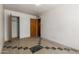 Bedroom featuring doors to the closet and bathroom; light walls and patterned flooring at 3302 W Turney Ave, Phoenix, AZ 85017