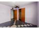 Bedroom has a closet and bright lighting, light walls, and patterned flooring at 3302 W Turney Ave, Phoenix, AZ 85017