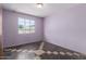 Bedroom showcasing a window view, light walls, and unique patterned flooring at 3302 W Turney Ave, Phoenix, AZ 85017