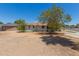 Single story home featuring a front yard with mature trees and a gravel landscape at 3302 W Turney Ave, Phoenix, AZ 85017