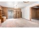 Living room features wood paneling, a built-in bookshelf, and a sliding glass door at 3302 W Turney Ave, Phoenix, AZ 85017