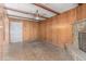 Living room features wood paneling, a stone fireplace, exposed beams, and a ceiling fan at 3302 W Turney Ave, Phoenix, AZ 85017