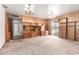 Living room features wood paneling, a built-in bookshelf, and a sliding glass door at 3302 W Turney Ave, Phoenix, AZ 85017