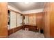 A bedroom with wood paneling, carpet and sliding closet doors at 4065 E University Dr # 141, Mesa, AZ 85205