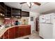A kitchen featuring wood cabinets, a stainless sink, and a white refrigerator at 4065 E University Dr # 141, Mesa, AZ 85205