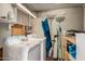 Laundry room featuring washer and dryer, overhead lighting, and pegboard walls at 4065 E University Dr # 141, Mesa, AZ 85205