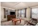 Comfortable living room with a TV and a classic coffee table, bathed in natural light at 4065 E University Dr # 141, Mesa, AZ 85205