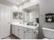 Bright bathroom featuring a white vanity, a large mirror and a toilet next to the cabinet at 4202 E Broadway Rd # 130, Mesa, AZ 85206