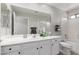 Well-lit bathroom boasts a spacious vanity, a large mirror, and a combo shower-tub with a toilet on the side at 4202 E Broadway Rd # 130, Mesa, AZ 85206
