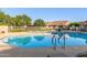 Inviting community pool featuring clear blue water, poolside seating, and beautiful residential surroundings at 4202 E Broadway Rd # 130, Mesa, AZ 85206