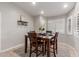 Cozy dining room with a dark wood table, seating for four, and plantation shutters that create an inviting space at 4202 E Broadway Rd # 130, Mesa, AZ 85206