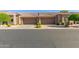 Inviting exterior view of townhome with a private two-car garage, manicured landscaping, and a charming tile roof at 4202 E Broadway Rd # 130, Mesa, AZ 85206