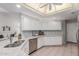 Bright kitchen featuring white cabinets, tiled backsplash, and granite countertops at 4202 E Broadway Rd # 130, Mesa, AZ 85206