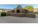 Inviting outdoor fireplace with unique design and decorative urns on a concrete patio, ideal for cozy evenings at 4202 E Broadway Rd # 130, Mesa, AZ 85206