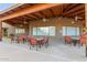 Inviting outdoor patio area featuring comfortable seating, a covered space, and charming landscaping, perfect for gatherings at 4202 E Broadway Rd # 130, Mesa, AZ 85206