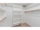 Walk-in closet features a built-in shelving system and wood rod for hanging clothes at 4202 E Broadway Rd # 130, Mesa, AZ 85206