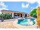 This backyard is complete with a private pool, hot tub, and covered patio offering the ultimate outdoor living experience at 42318 W Abbey Rd, Maricopa, AZ 85138