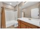 This bathroom features a single sink vanity and shower-tub combo with neutral finishes, ideal for comfortable living at 42318 W Abbey Rd, Maricopa, AZ 85138