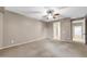 Large bedroom featuring a ceiling fan and an ensuite bathroom at 42318 W Abbey Rd, Maricopa, AZ 85138