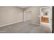 This bedroom is complete with plush carpeting, a mirrored closet, and an en-suite bathroom for added convenience at 42318 W Abbey Rd, Maricopa, AZ 85138