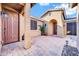 Inviting courtyard with pavers leading to the double-door front entrance and an arched entry to the house at 42318 W Abbey Rd, Maricopa, AZ 85138
