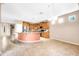 Open kitchen with a breakfast bar, stainless steel appliances, and an adjacent open floorplan at 42318 W Abbey Rd, Maricopa, AZ 85138