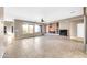 Spacious living room with tile flooring, fireplace, and built-in shelving at 42318 W Abbey Rd, Maricopa, AZ 85138