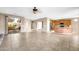 Open floor plan with tile flooring connecting the living room, kitchen, and dining areas at 42318 W Abbey Rd, Maricopa, AZ 85138
