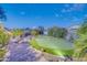 Entertainer's dream backyard with a custom putting green, bar and BBQ area, and lush landscaping at 42318 W Abbey Rd, Maricopa, AZ 85138