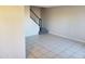 Spacious living area with tile flooring and staircase, offering ample space for furniture arrangement at 4236 S 46Th Pl, Phoenix, AZ 85040
