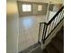 A spacious living room featuring tiled floors and staircase at 4236 S 46Th Pl, Phoenix, AZ 85040
