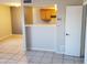 Bright living area featuring tile floors, a serving bar, and access to the kitchen space at 4236 S 46Th Pl, Phoenix, AZ 85040