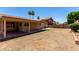 Covered patio at the back of a house, overlooking a large, dirt backyard at 4336 E Aspen Ave, Mesa, AZ 85201